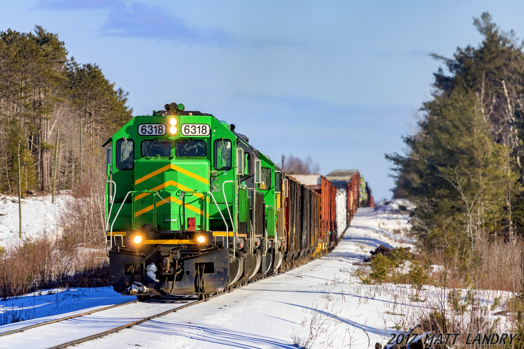 NBSR 6318 leads a westbound New Brunswick Southern Railway freight, as they negotiate the terrains of the McAdam Sub, approaching Cork, New Brunswick.
