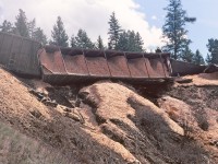 A bad day for trains. The "WP" switcher on a sunny spring morning encountered a washout at mile 349 on the BC Rail Prince George subdivision. Fortunately the locomotives made it over the washout culvert, unfortunately some of the chip cars did not traverse the track that well. The derailment was quite viz-able to the motorists on highway 97. The ultimate cause was done by the Department of Highways destroying a beaver dam on Hill Road. When the offending dam was dynamited, the sudden water flow overwhelmed the culvert on the railway right of way, causing a washout. No train crew injuries, the beaver was left homeless and moved elsewhere.