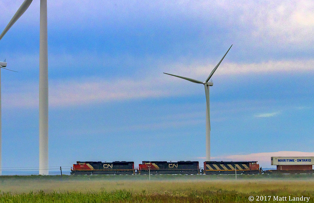 Heading through a bit of fog & mist, CN 120 heads by some turbines, as they approach Amherst, Nova Scotia.