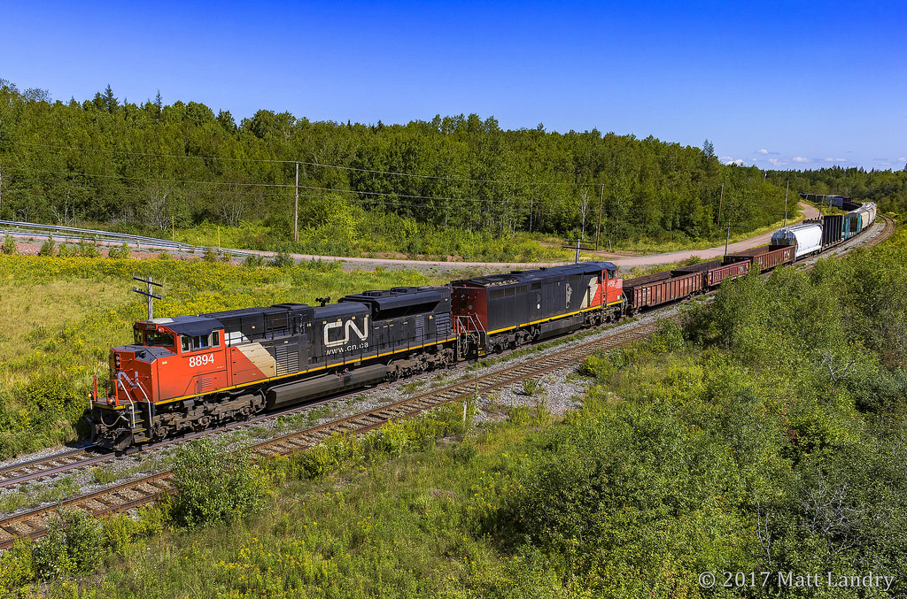 CN 8894 has no issues keeping track speed, as they lead a small 407, rounding the bend at Springhill Jct, Nova Scotia.
