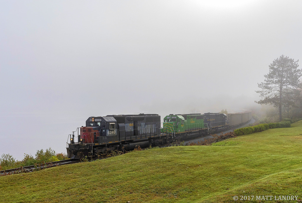 NBSR 6340 leads a New Brunswick Southern Railway westbound freight, as they round the edge of the Saint John River, which is pretty much non existent due to the heavy fog blanketing the area.