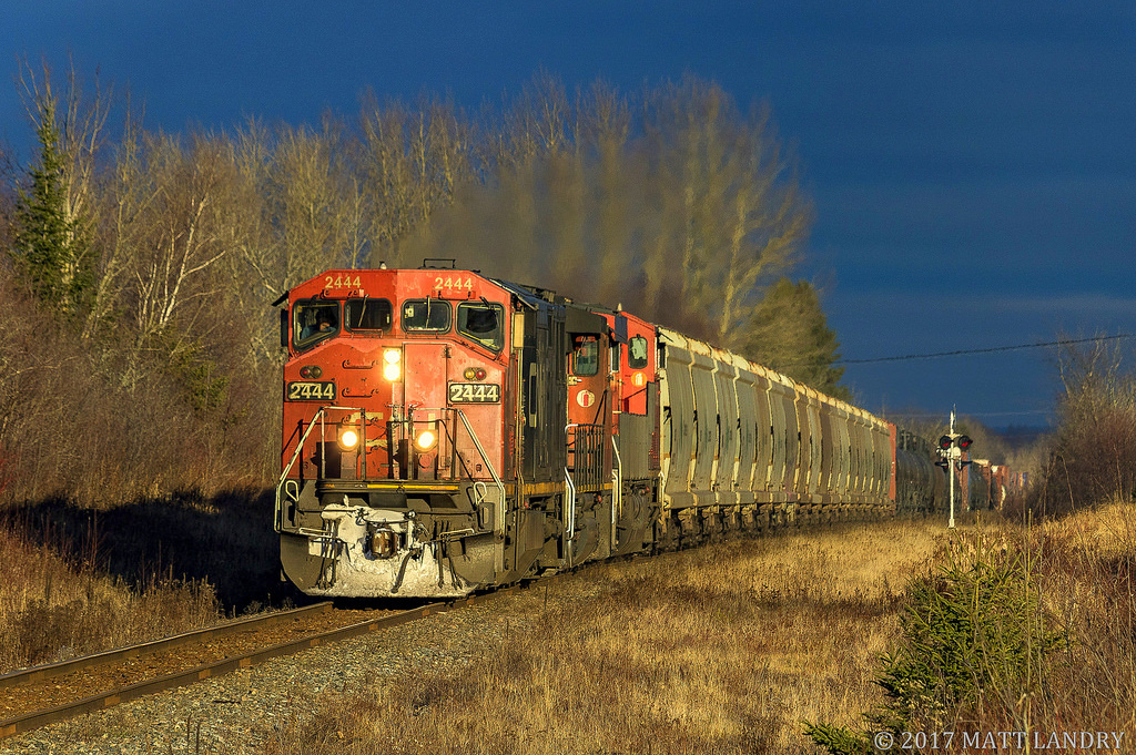In some nice storm light, CN 2444 leads train 406, as they head through Apohaqui, New Brunswick.