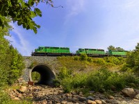 Plenty of green in this shot, as NBSR 6319 leads a New Brunswick Southern Railway westbound freight, as they head through Grand Bay, New Brunswick. 