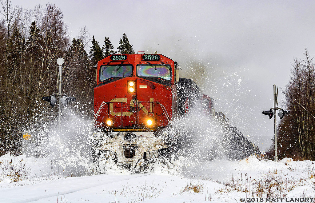 CN 2526 leads train 406 through a snowbank the day after a snowstorm hit the area, as they approach Sussex, New Brunswick.