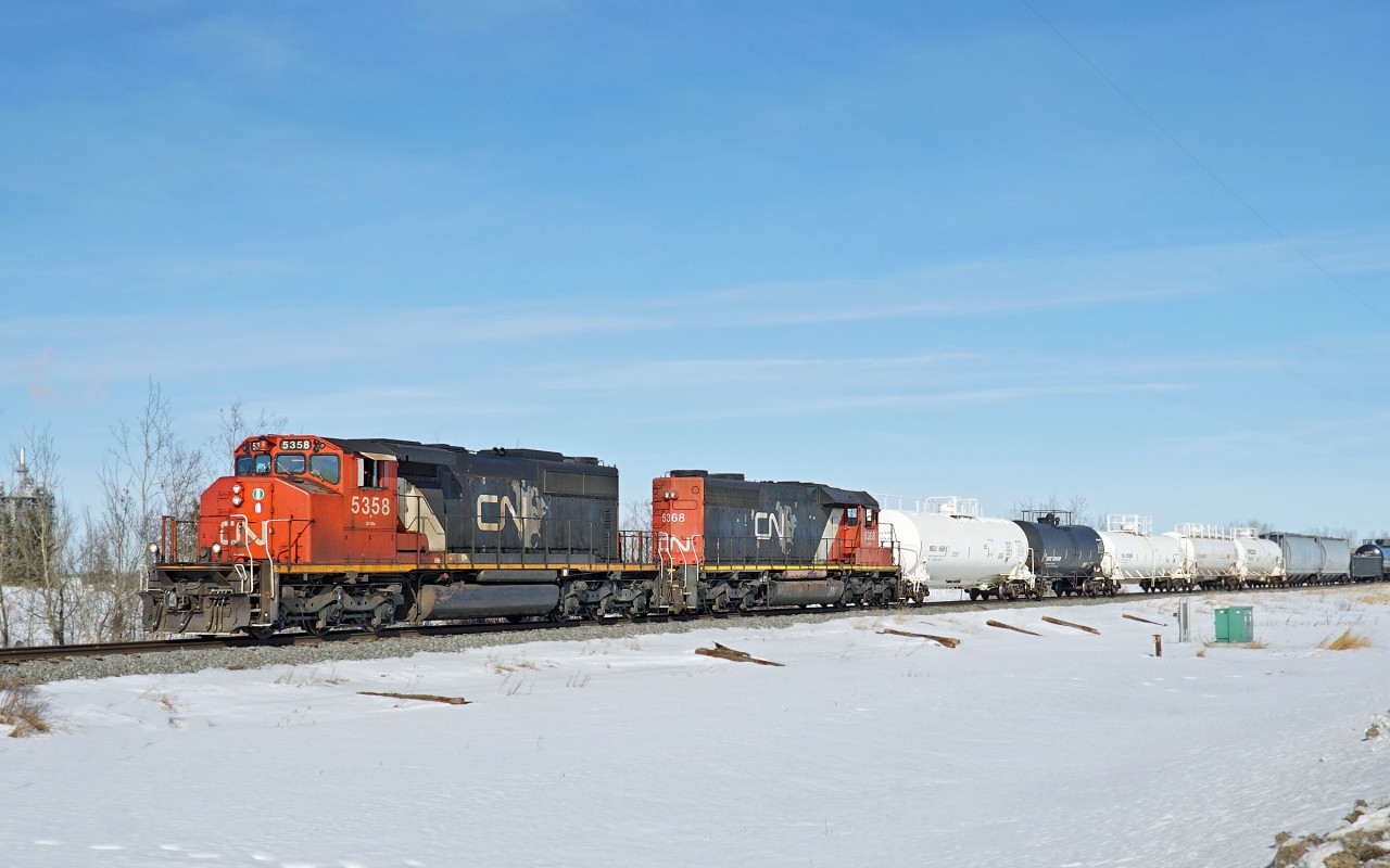 SD40-2(W) CN 5358 and SD40-2 CN 5368 head down the Fort Saskatchewan Industrial lead with the afternoon cut of cars for DOW and the other industries along the line.