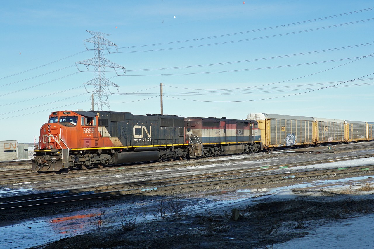 Caught these two sitting in the afternoon sun at Clover Bar Yard.  SD75I CN 5655 and BCOL 4625, originally a Dash 8  now rebuilt to Dash 9 specs. Not sure if they were waiting for a meet or dropping off auto racks.  Clover bar has a large unloading area for auto racks.