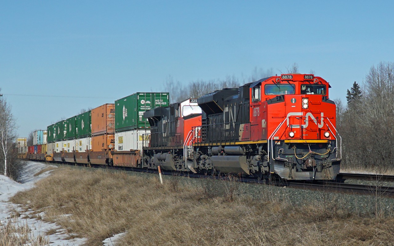 SD70M-2 CN 8878 and ES44DC CN 2259 head an eastbound intermodal approaching Uncas on CN's Wainwright Sub.