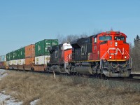 SD70M-2 CN 8878 and ES44DC CN 2259 head an eastbound intermodal approaching Uncas on CN's Wainwright Sub. 