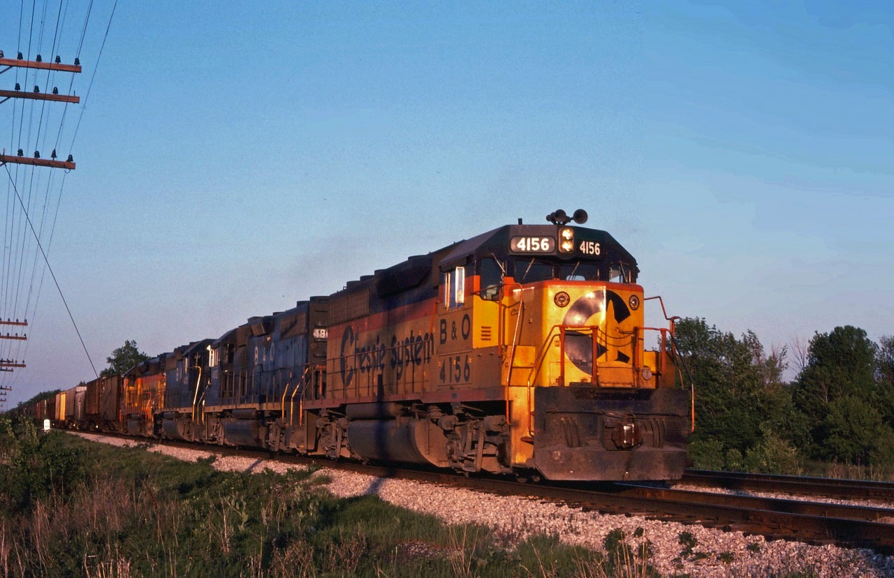 A Chessie eastbound heads into the morning sun behind a mixture of GP40s and GP38s.