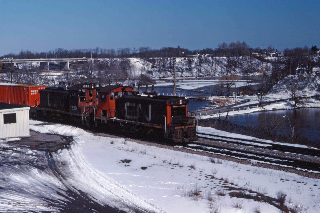 Winter snows linger but spring is definitely coming as CN road switcher 538 makes its way back to Hamilton with some container traffic on head end. Two SW120RS units were the normal power for this train (1204 and 1320 today).