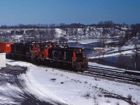 Winter snows linger but spring is definitely coming as CN road switcher 538 makes its way back to Hamilton with some container traffic on head end. Two SW120RS units were the normal power for this train (1204 and 1320 today).