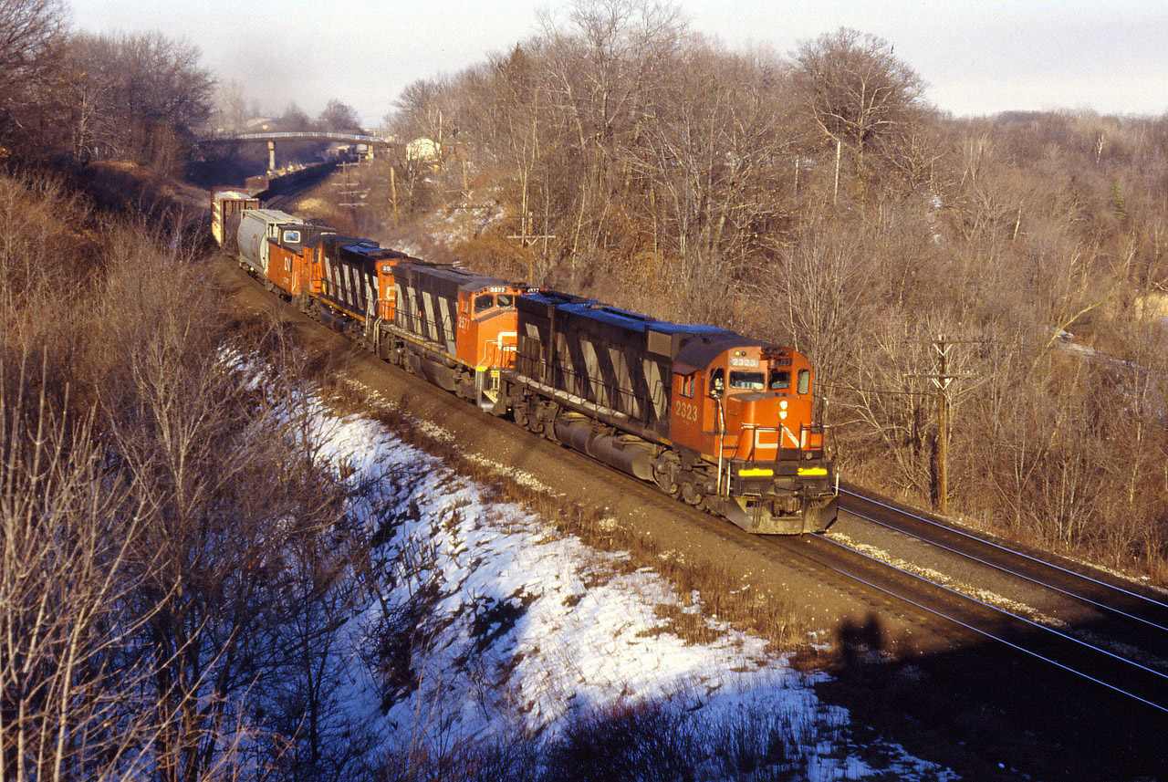 CN M636 2323 leads M420W 2577 and a C630m through Bayview with a westbound freight in a late winter 1987 shot.