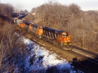 CN M636 2323 leads M420W 2577 and a C630m through Bayview with a westbound freight in a late winter 1987 shot.