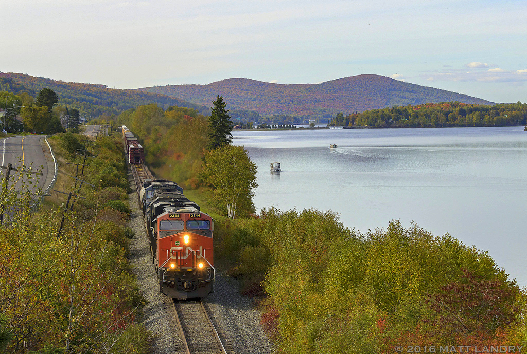 CN 2344 is eastbound, leading train M306 along the scenic Lac Baker, about 24 miles north west of Edmundston, New Brunswick. Unfortunately, I was probably a week or two early to get the Fall colors in full force, but they still look alright.