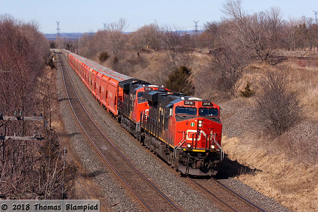 With only the lack of snow suggesting that springtime has arrived, the loaded Saskatchewan to New Brunswick potash unit train rolls through Lovekin on a sunny Saturday. Powered by four units - CN 2818 and 3118 up front, 2958 as mid-train DPU, and 2812 on the rear - this is certainly one of the heaviest trains on CN right now (in this part of Canada anyway).