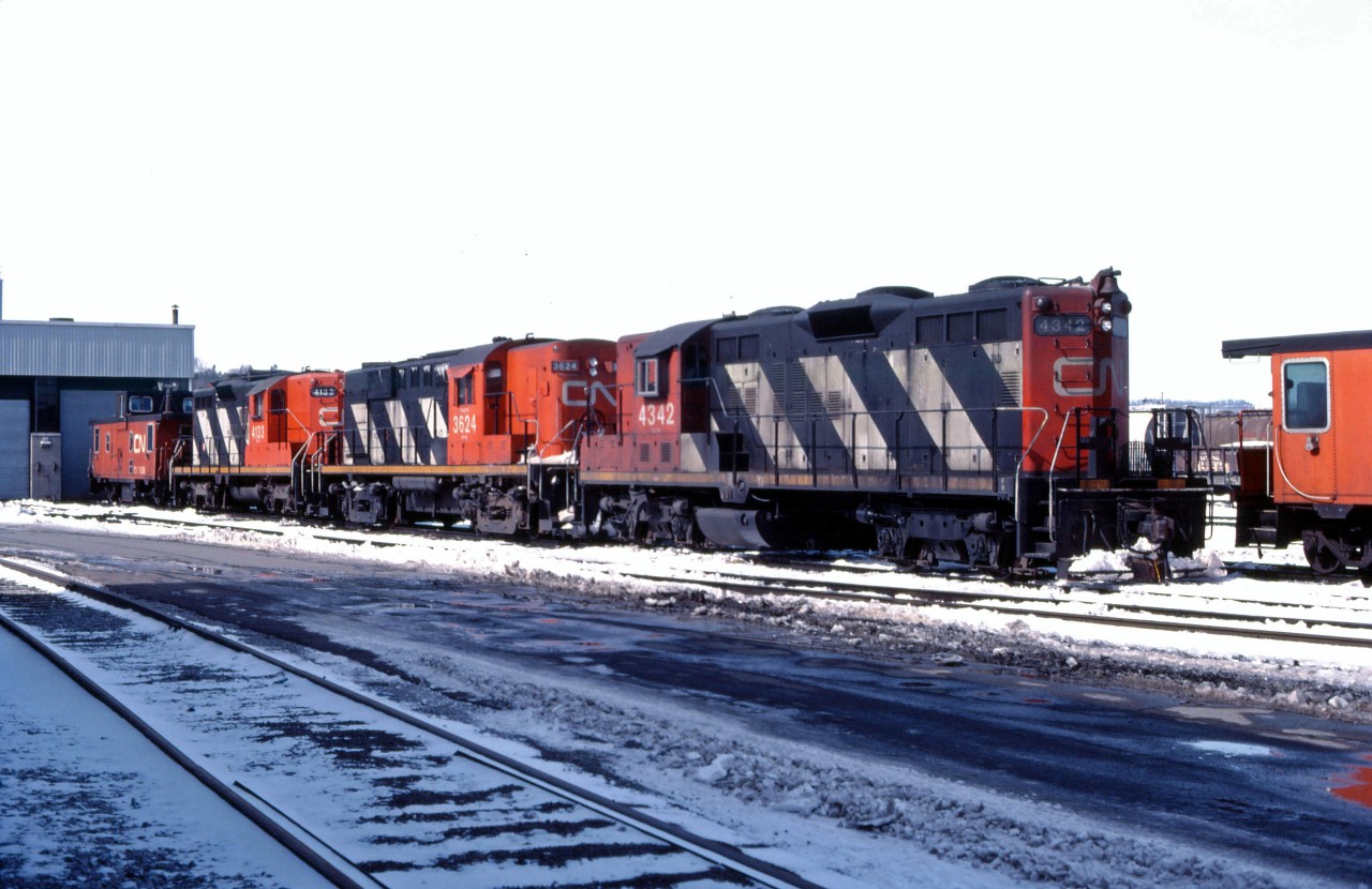 A couple of recent arrivals from western Canada ("light weight" GP9s 4342 and 4133) bracket a visitor from Atlantic Canada (RS18 3624) outside the Stuart Street diesel shop in Hamilton on a winter morning in 1984. These units likely will be the power for this afternoon's "steel train" 725 to Nanticoke. (Slide was processed in April 1984.)