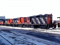 A couple of recent arrivals from western Canada ("light weight" GP9s 4342 and 4133) bracket a visitor from Atlantic Canada (RS18 3624) outside the Stuart Street diesel shop in Hamilton on a winter morning in 1984. These units likely will be the power for this afternoon's "steel train" 725 to Nanticoke. (Slide was processed in April 1984.)