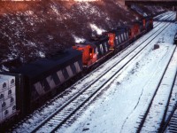 An eastbound passes CN's Hamilton station on its way to Niagara (likely Fort Erie). Power on the train is (from furthest to nearest unit) CN GP40-2LW 9502, an unidentified RS18, C630m 2030, GP9 4525, and F7Bu 9195. While still used as a passenger station, at least four of the six tracks at the James Street North station are now devoted to freight car repairs and track six holds a maintenance of way crane.