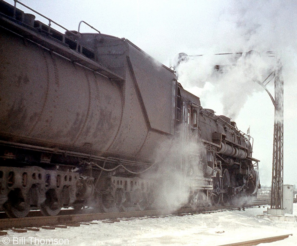 CN 4-8-4 Northern 6300 steams past the signals eastbound at Port Credit, on a snowy day in 1954. 6300, based out of Mimico Roundhouse, was the class unit of the U3a group of former GTW 6300-6311 Northerns that were transferred north of the border.

More CNR/GTW 6300's:
Front view of 6300: http://www.railpictures.ca/?attachment_id=28667
6301 passing by Clarkson Station: http://www.railpictures.ca/?attachment_id=13305
6301 at Mimico Roundhouse: http://www.railpictures.ca/?attachment_id=26621