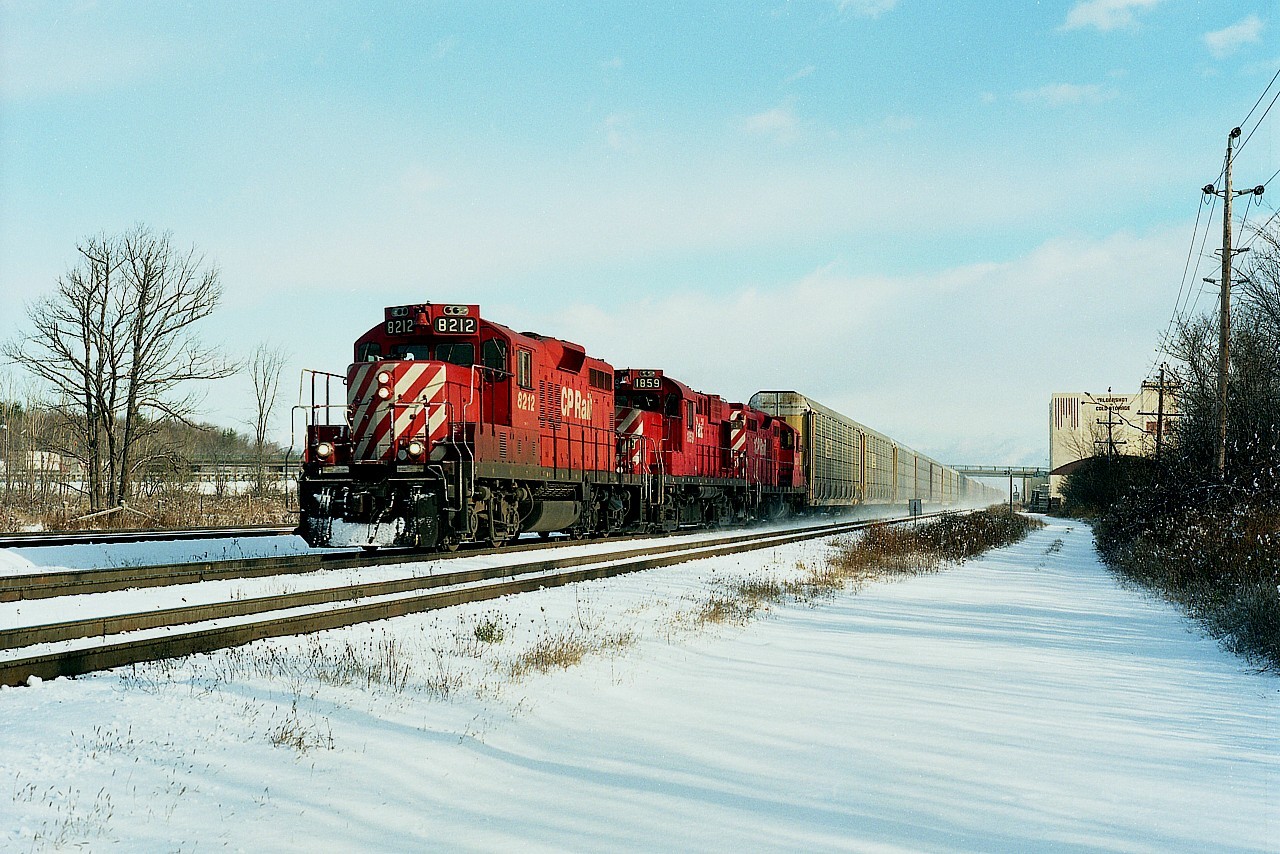 Really nice cold morning in late November of '94 and I was parked up at the end of Howard Rd in Aldershot, a favourite place back before the third track went in (for GO expansion). Now, it is pretty well inaccessible for decent mainline photos. In this shot, CP still had rights over the CN thru here, and CP 8212, 1859 and 8234 are moving along at speed.  Aldershot Cold Storage building (now gone) and Waterdown Rd bridge in the background. Image is from a medium format print.
