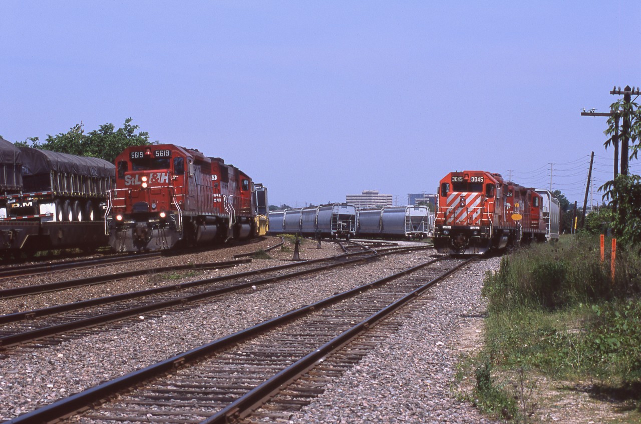 It's a busy morning at Streetsville Junction as Expressway train 123 is westbound on the south while eastbound 419 is on the north, then off to the side is the "stone-train" doing it's thing.