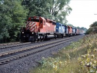 A CP eastbound approaches Campbellville with two leased former Conrail GP38s, as well as a CP SD40-2 and an SD40 in the summer of 1985.