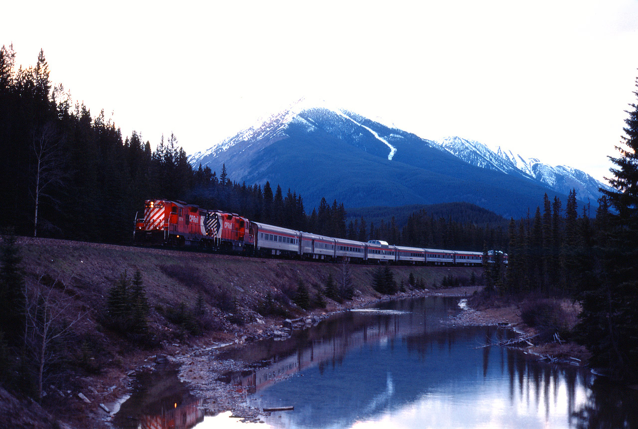 During the last months of CP operation, "the Canadian" heads west on the Laggan sub. In a few minutes, GP9s 8514 and 8522 will pass through the spiral tunnels and bring their eight car train into Field. It is still the "shoulder" season ahead of summer's peak and so No. 1 has a deadhead coach, baggage-dormitory, one coach, a Skyline car, a diner, two Manor sleepers and the "Park" dome-observation car. VIA took over CP's passenger operations on October 29, 1978.