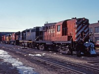 Two sets of power rest at the TH&B Chatham Street roundhouse in the early spring of 1984. We see RS18 8791 and leased C&O GP38 4828 as well as C424 4227, B&O 4806, and C424 4207. The three unit consist would later power the steel train west over the Waterford sub.