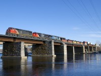 CN 2432, CN 5442 & IC 2459 lead a 574-axle long CN 149 over the Ottawa River as they leave Montreal on an unexpectedly sunny morning.