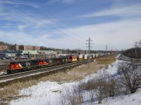  CN 149 has a trio of older units with CN 2009, IC 1031 & CN 2190 for power as it heads west through Pointe-Claire after lifting and rearranging cars at Turcot West.