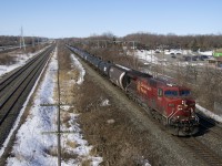 CP 8575 leads loaded ethanol train CP 650 through Beaconsfield. Pushing at the rear is NS 7295 and at left is the parallel CN Kingston Sub.