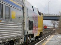 CN 585 is approaching Dorval Station as VIA 624 with VIA 912 leading departs after making its station stop.