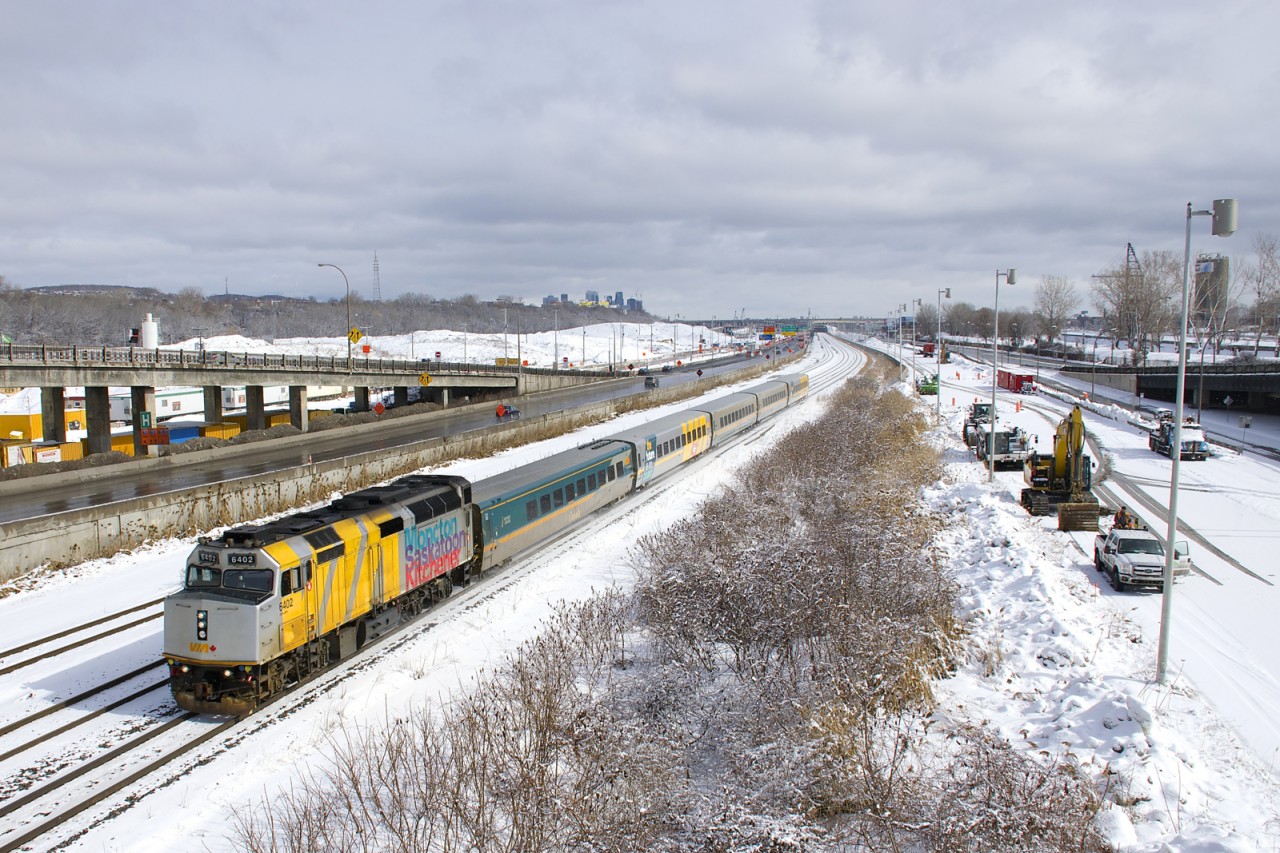 Wrapped unit VIA 6402 was stranded in Churchill for much of 2017 (along with an entire trainset) due to flooding of the rail line that leads to Churchill in the spring of 2017. This equipment was moved to Montreal by boat towards the end of 2017 and that equipment is now back in service. Here VIA 6402 leads VIA 65 past equipment working on demolishing the westbound lanes of autoroute 20, which were moved northwards recently. VIA 6402 does not have a Canada 150 or a VIA 40 logo at the moment, but two of of the coaches do have VIA 40 logos.