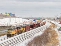 UP 6589 & UP 8076 lead a short 20-car CN 529 on CN's Montreal Sub, with the skyline of downtown Montreal in the background. This view will be gone by the end of the year, with CN's main line moving a bit further north (to the left in this picture).