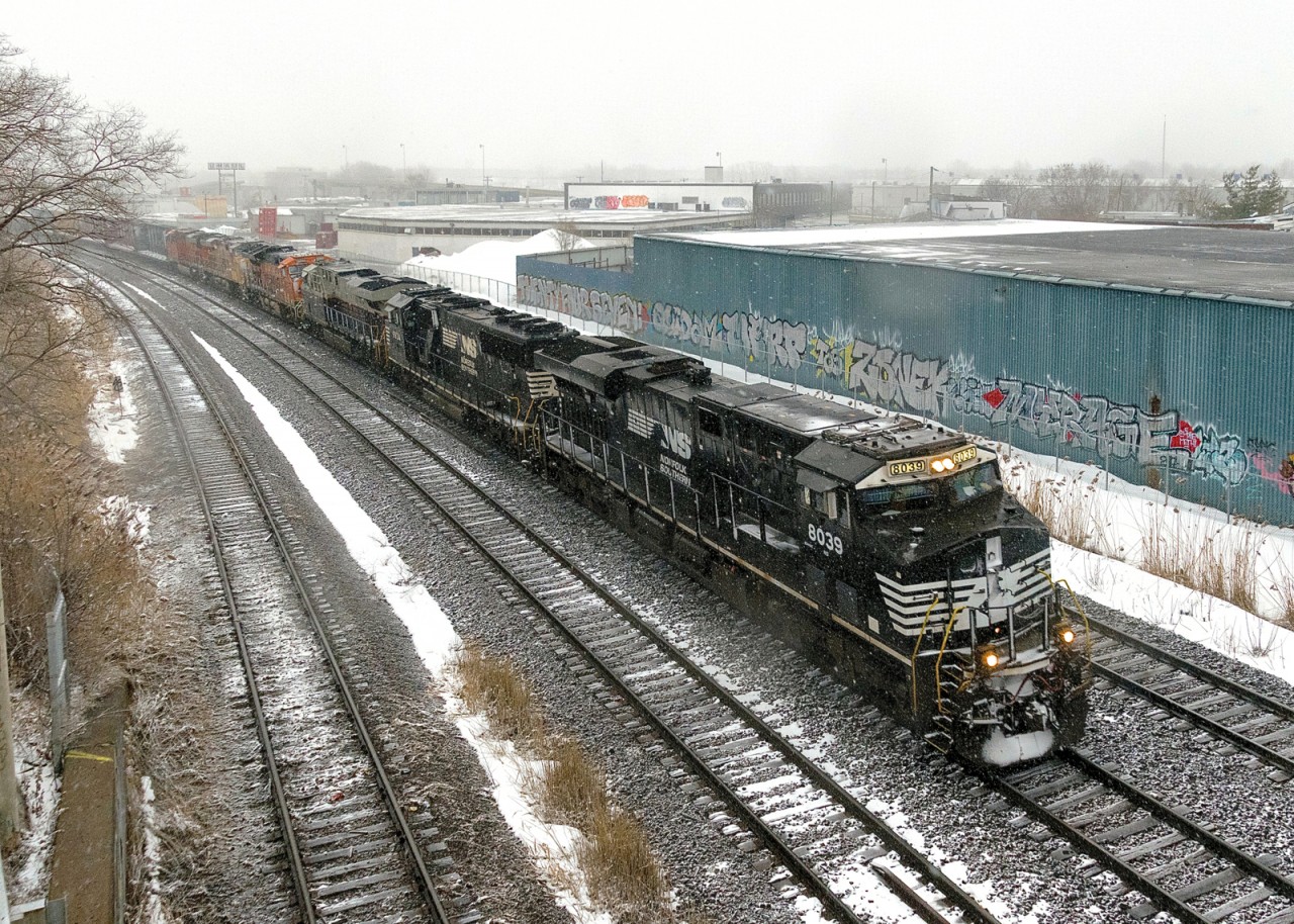 Two days worth of CN 529 have been combined as a 6-unit CN 529 heads through Montreal West in the driving snow. Lashup is NS 8039, NS 6934, NS 8101 (the Central of Georgia unit), BNSF 3895, UP 7361 & BNSF 7457, with 52 cars.
