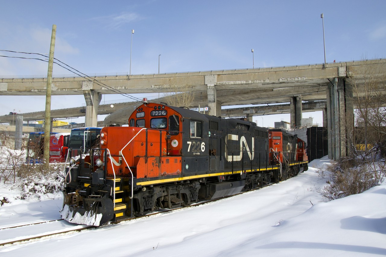 GP9's CN 7226 & CN 7075 have just passed under the Turcot interchange, which is being demolished and rebuilt, with some sections already gone. They are on the Turcot Holding Spur, which branches off of CN's Montreal Sub at MP 4 and serves a pair of clients at the end of the line, a short distance away. They will pick up some empties and then head to the East Side Canal Bank.