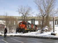 A crewmember is about to flag the Monk Boulevard crossing before the Pointe St-Charles switcher continues west on the Turcot Holding Spur, which branches off of CN's Montreal Sub at MP 4 and serves a pair of clients at the end of the line, a short distance away. GP9's CN 7226 & CN 7075 will pick up some empties at Kruger and then head to the East Side Canal Bank. 