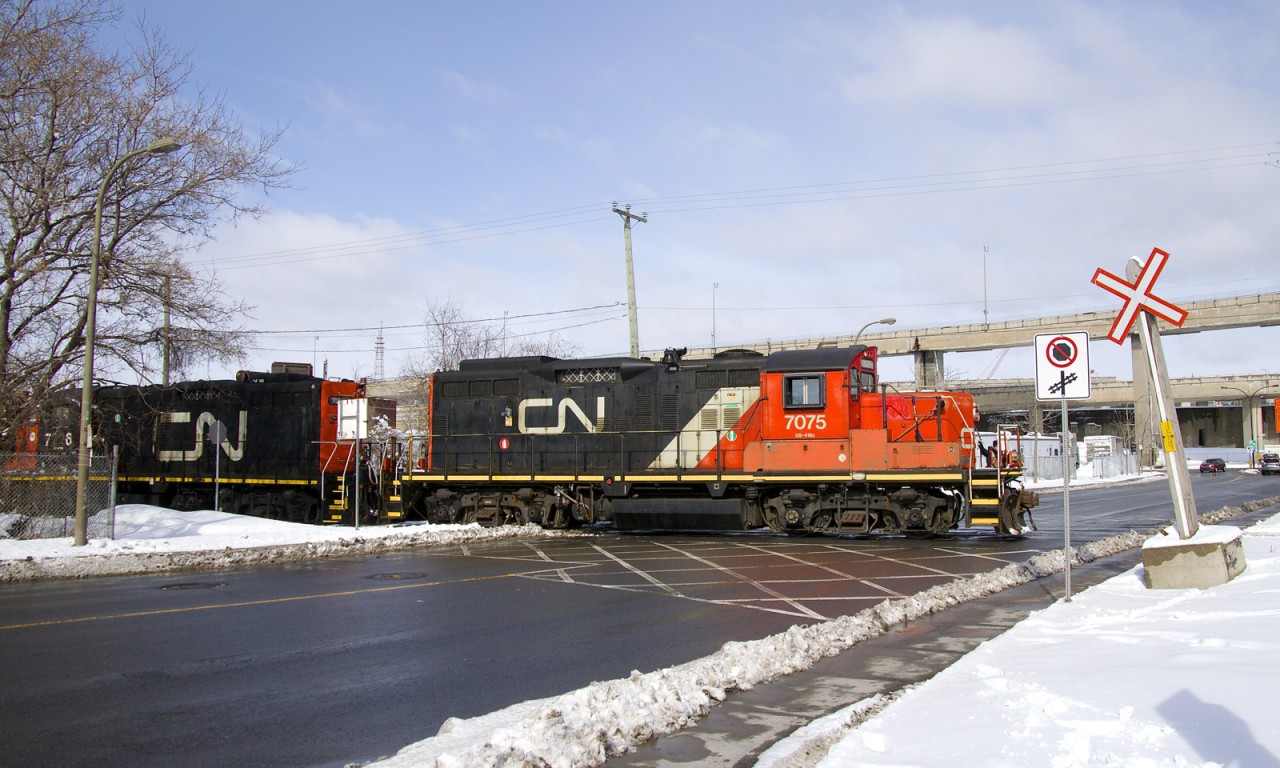 GP9's CN 7075 & CN 7226 are crossing Monk Boulevard as they do some switching on the Turcot Holding Spur.