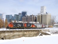  The Pointe St-Charles Switcher has GP9's CN 7226 & CN 7075 for power as it prepares to leave the Ardent Mill after picking up eight grain empties on CNs East Side Canal Bank Spur (the last client remaining on this line). In the distance at left is the skyline of downtown Montreal and in the foreground is the frozen and snow-covered Lachine Canal.