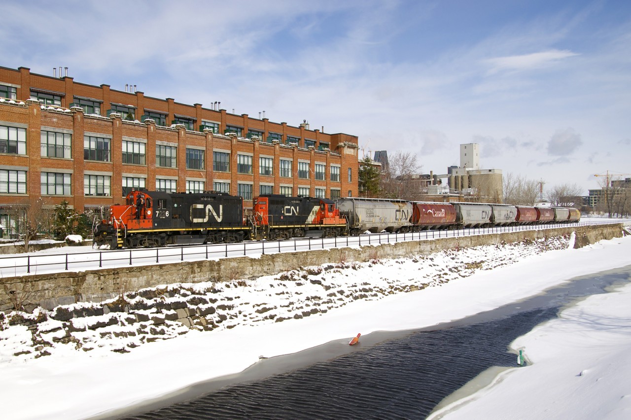 The Pointe St-Charles Switcher has GP9's CN 7226 & CN 7075 as it heads west along the partially frozen Lachine Canal. It just left the Ardent Mill after picking up eight grain empties on CN's East Side Canal Bank Spur (the last client remaining on this line).