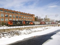 The Pointe St-Charles Switcher has GP9's CN 7226 & CN 7075 as it heads west along the partially frozen Lachine Canal. It just left the Ardent Mill after picking up eight grain empties on CN's East Side Canal Bank Spur (the last client remaining on this line). 