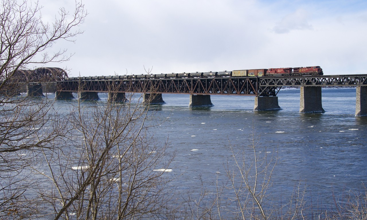 Empty ethanol train CP 651 has CP 8575 & CP 8754 for power, along with 2 buffer cars and 94 empty tank cars as it crosses the St. Lawrence River into Montreal.