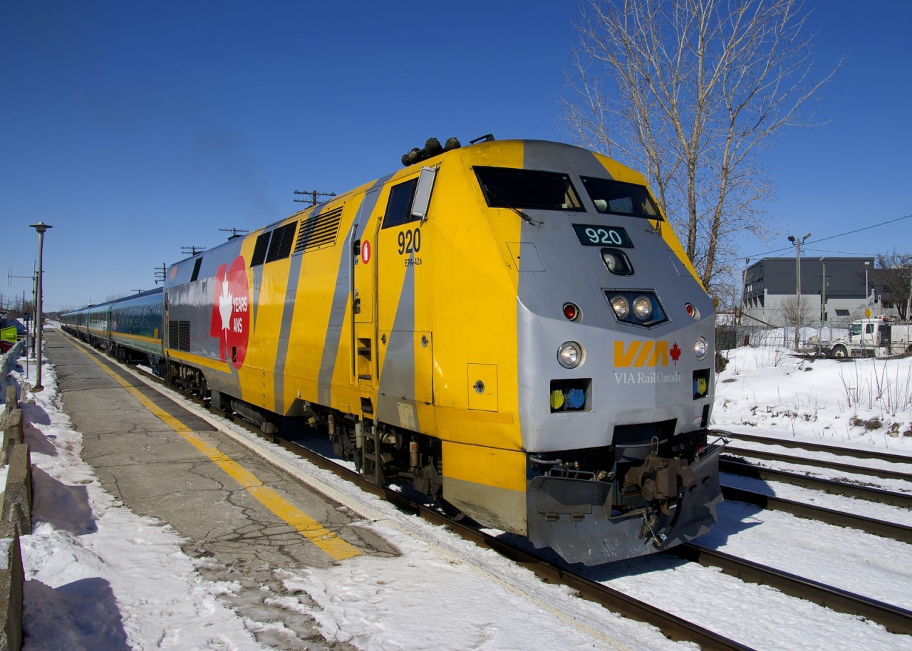 IA 624 with VIA 920 in VIA 40 wrap is departing Dorval Station.