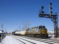 Leased unit CREX 1510 leads CN 368 as it passes under a signal gantry near Dorval Station as the train crosses from the north track to DX-1 track. Mid-train is CN 2903.