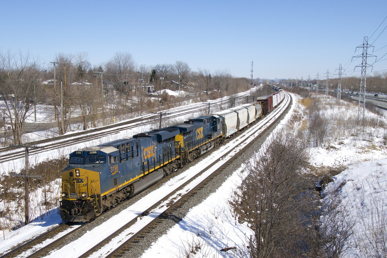 CSXT 3196 & CSXT 525 lead a 113-car CN 327 around a curve in Beaconsfield on a cold but sunny afternoon.