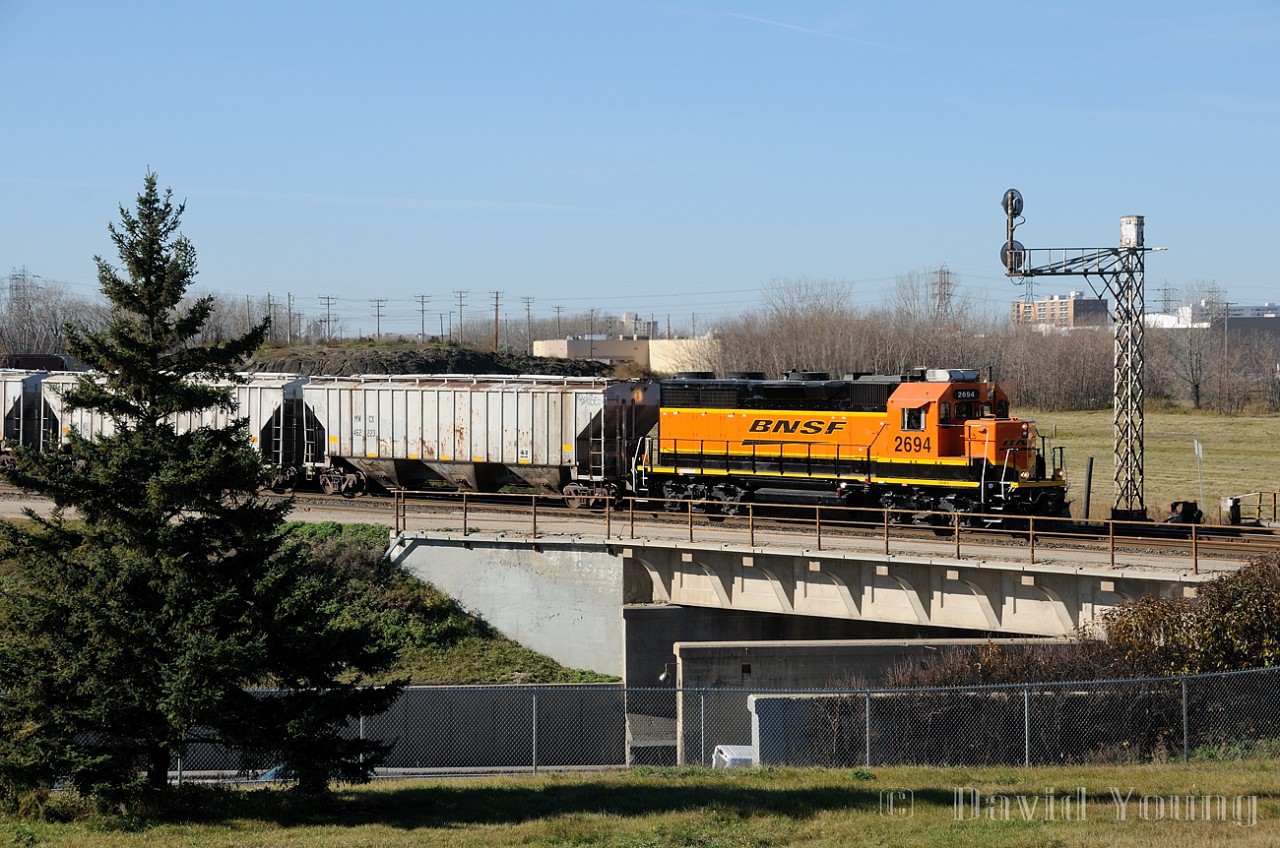 Rolling above the Pembina Highway, BNSF GP39-3 leads a lengthy drag of cars ex BNML trackage to the west and into CN's Fort Rouge yard. CN will haul the traffic south to interchange with BNSF at Emerson,MB/Noyes, Minnesota.