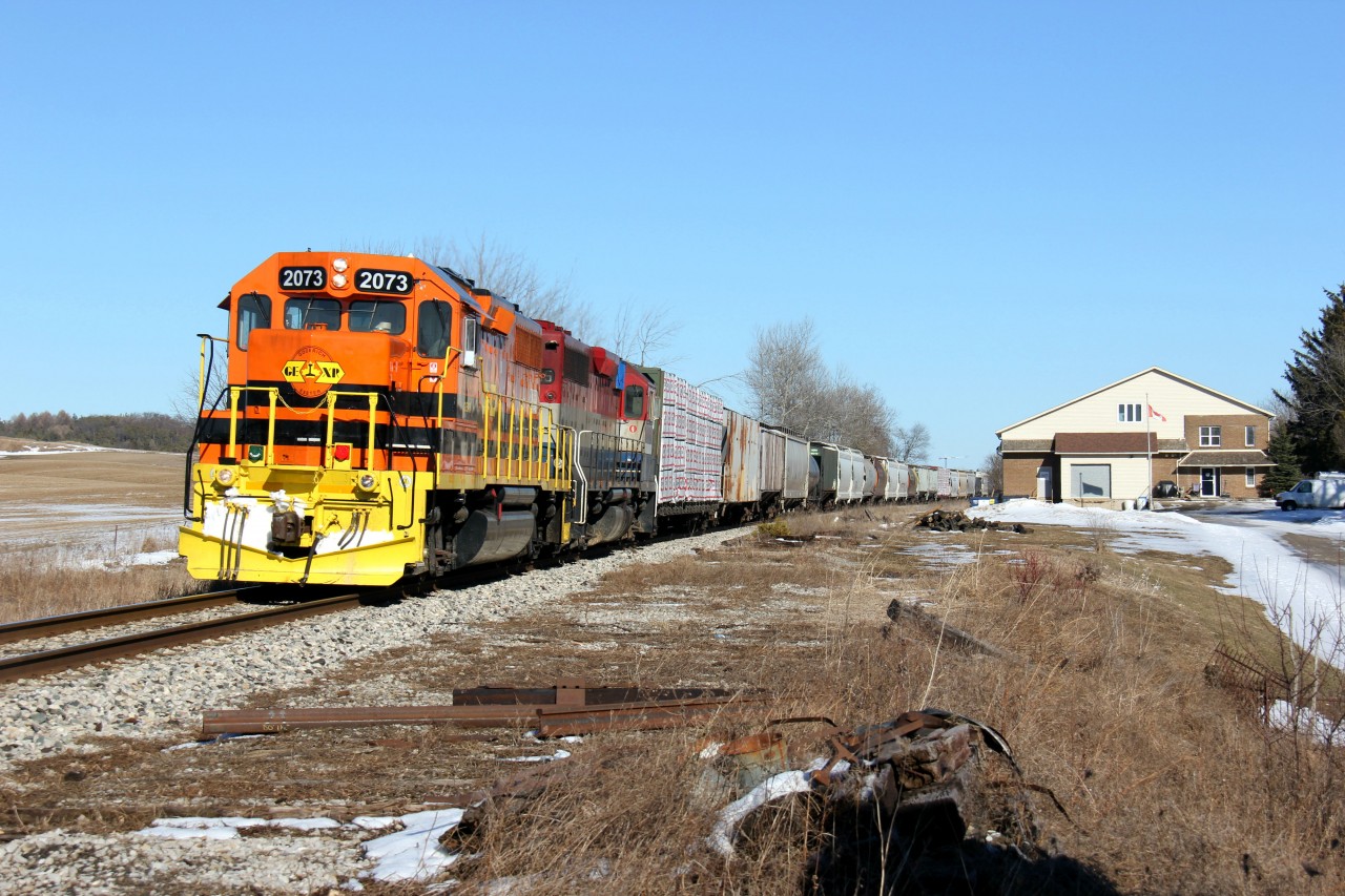 GEXR 582 heads back to Stratford, after doing work in Kitchener and Guelph, with GEXR 2073 and RLK 4095 on the point. It is pictured rounding the bend through the village of Petersburg west of Kitchener on this fine St. Patrick's Day 2018. Note the evidence of the former siding track, now removed. Not sure if this siding was used much during GEXR operations but for a while after the line was leased to GEXR from CN, the CN Petersburg sign and siding remained.