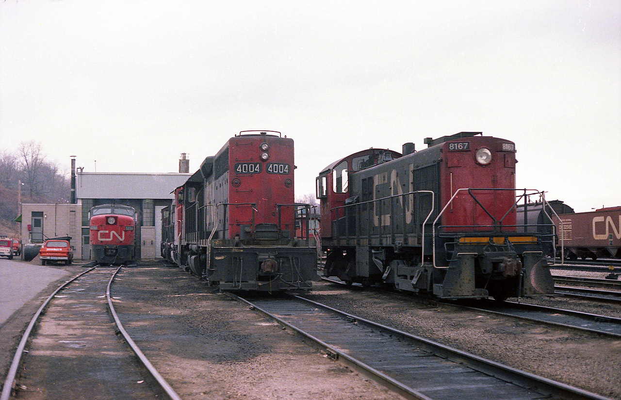 A rather quiet quiet day at the old Stuart St CN enginehouse many years ago. Odd visitor CN 6758 was disabled due to some unknown (to me) mechanical failure and CN 4004 was being readied to assist the dead unit back to Toronto.  The CN 8167 is on standby as a local yard switcher.  This MLW S-4 was retired by 1985. As well, the enginehouse has recently been razed to make room for new GOcommuter trackage.