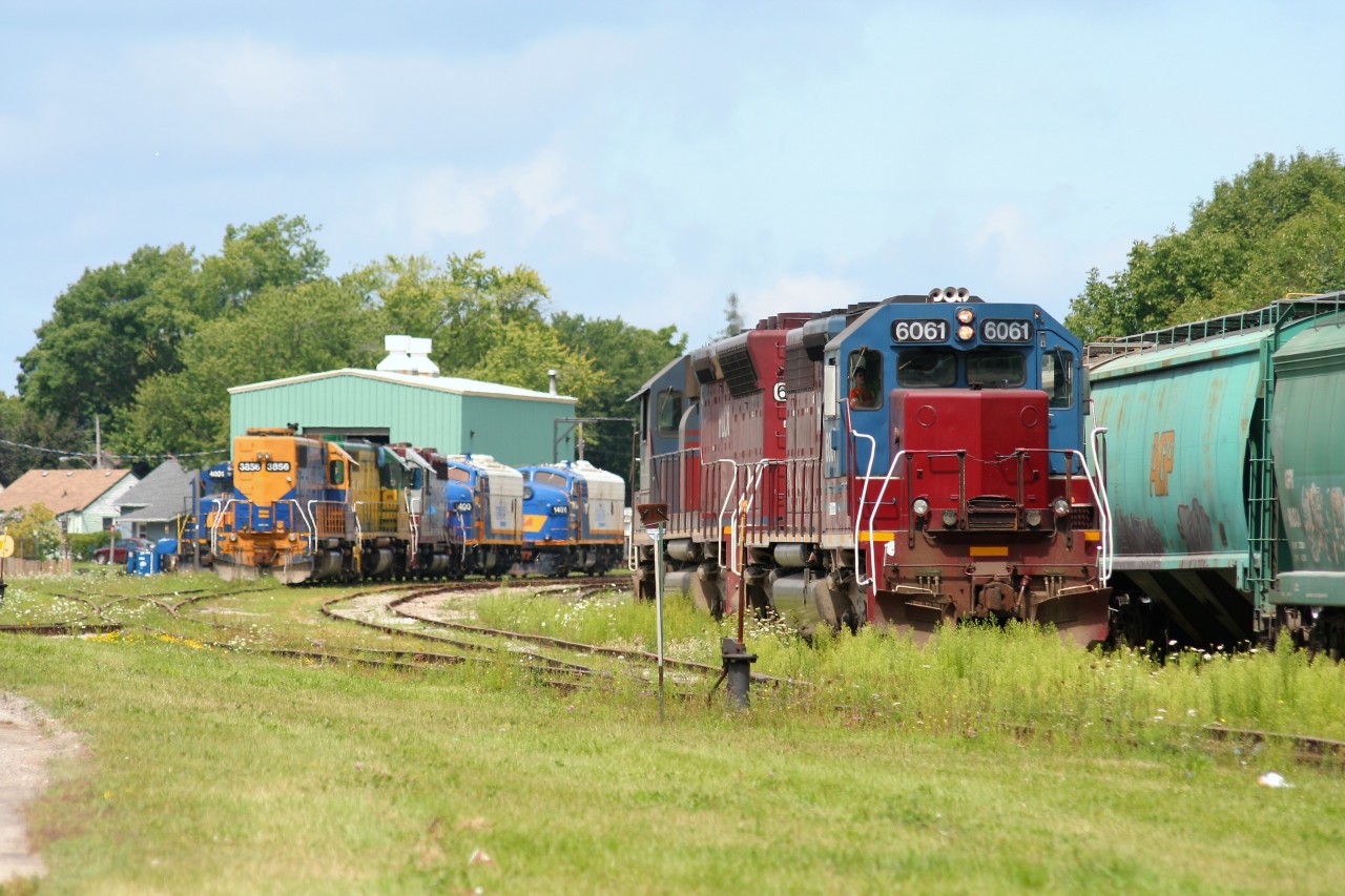 Goderich-Exeter Railway (GEXR) train 581 with HLCX SD40M-3’s 6061 and 6522 slowly roll by all the stored four-axle power at the railway’s Goderich, Ontario shop on an August afternoon almost ten years ago.