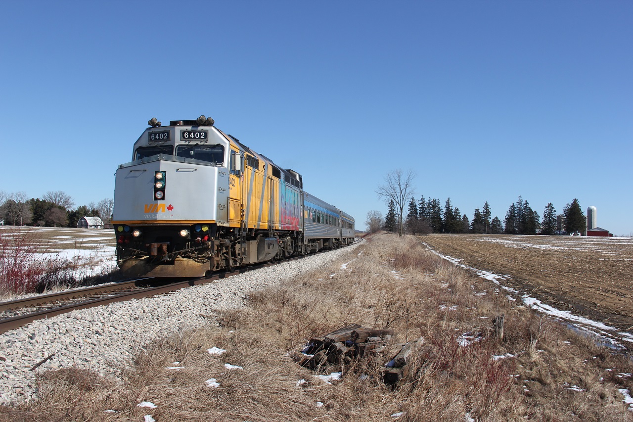 VIA 85 rolls westbound through the countryside between New Hamburg and Shakespeare, Ontario. It is obeying a slow order for the Highway 7 overpass.